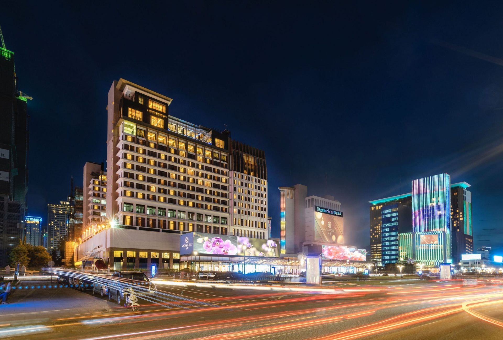 NagaWorld, a prominent landmark in Phnom Penh, is a comprehensive entertainment complex that offers a variety of attractions, including gaming, dining, drinking, entertainment, and shopping. It is often considered a central hub for both locals and tourists seeking luxury and excitement in the heart of Cambodia.  Gaming NagaWorld is renowned for its extensive casino facilities, featuring a wide array of gaming options:  Table Games: The casino boasts numerous tables for popular games such as blackjack, baccarat, roulette, and poker. Slot Machines: There are hundreds of slot machines catering to both novice and experienced players. VIP Gaming: For high rollers, NagaWorld offers exclusive VIP gaming rooms with personalized services​ (guestfriendlyhotelsasia)​​ (Agoda)​. Food The complex houses a variety of dining establishments that cater to different tastes and preferences:  Le Gourmet: Offers a sophisticated French dining experience with an extensive wine list. Fortune Palace: Specializes in Cantonese cuisine and is known for its dim sum and seafood dishes. The Pangea: A buffet restaurant providing international cuisine with live cooking stations​ (Agoda)​. Drinks NagaWorld features several bars and lounges where guests can enjoy a range of beverages:  Darlin Darlin Music Lounge: A stylish venue offering live music performances and an extensive drink menu. Lobby Lounge: Perfect for a relaxed evening with cocktails and light snacks​ (Agoda)​. Entertainment Beyond gaming and dining, NagaWorld offers various entertainment options:  Live Performances: Regular shows including traditional Cambodian performances, concerts, and international acts. KTV: Private karaoke rooms for those looking to sing and have a good time with friends​ (Agoda)​​ (Guest Friendly Hotels Guide)​. Girls NagaWorld is known for its vibrant nightlife scene, which includes hostess bars and lounges where visitors can enjoy the company of hostesses. The establishment ensures a high standard of safety and discretion for all its patrons​ (Guest Friendly Hotels Guide)​.  Shopping The NagaCity Walk, connected to NagaWorld, offers a luxurious shopping experience:  Luxury Brands: Stores featuring high-end fashion, jewelry, and accessories. Duty-Free Shops: A variety of duty-free options for travelers looking to purchase international goods at competitive prices​ (guestfriendlyhotelsasia)​​ (Guest Friendly Hotels Guide)​. NagaWorld stands out as a premier entertainment destination in Phnom Penh, providing a complete package of gaming, dining, drinking, entertainment, and shopping. Its luxurious facilities and diverse offerings make it a must-visit spot for anyone looking to experience the best of what the city has to offer.